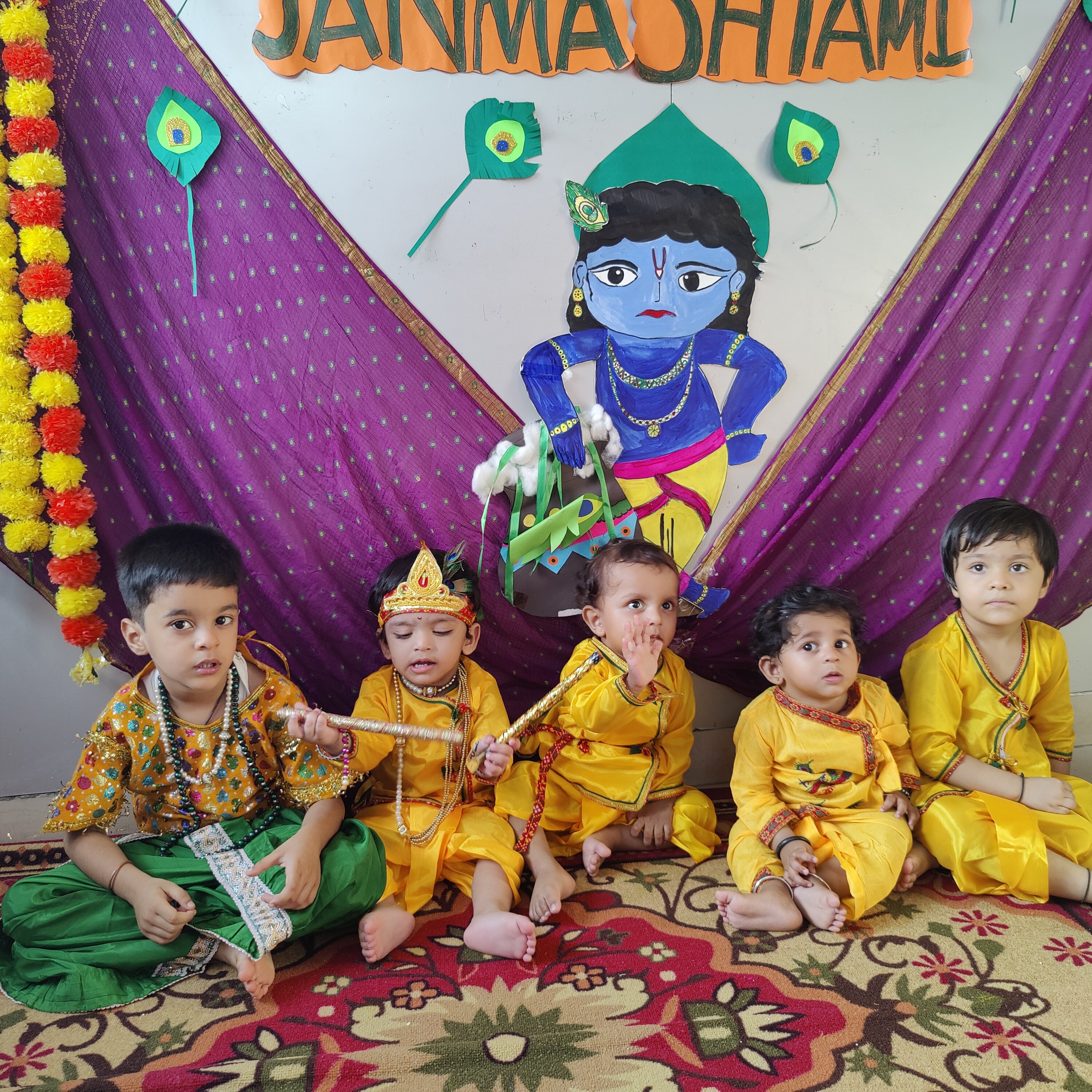Smiling kids posing during Janmashtami celebration at school