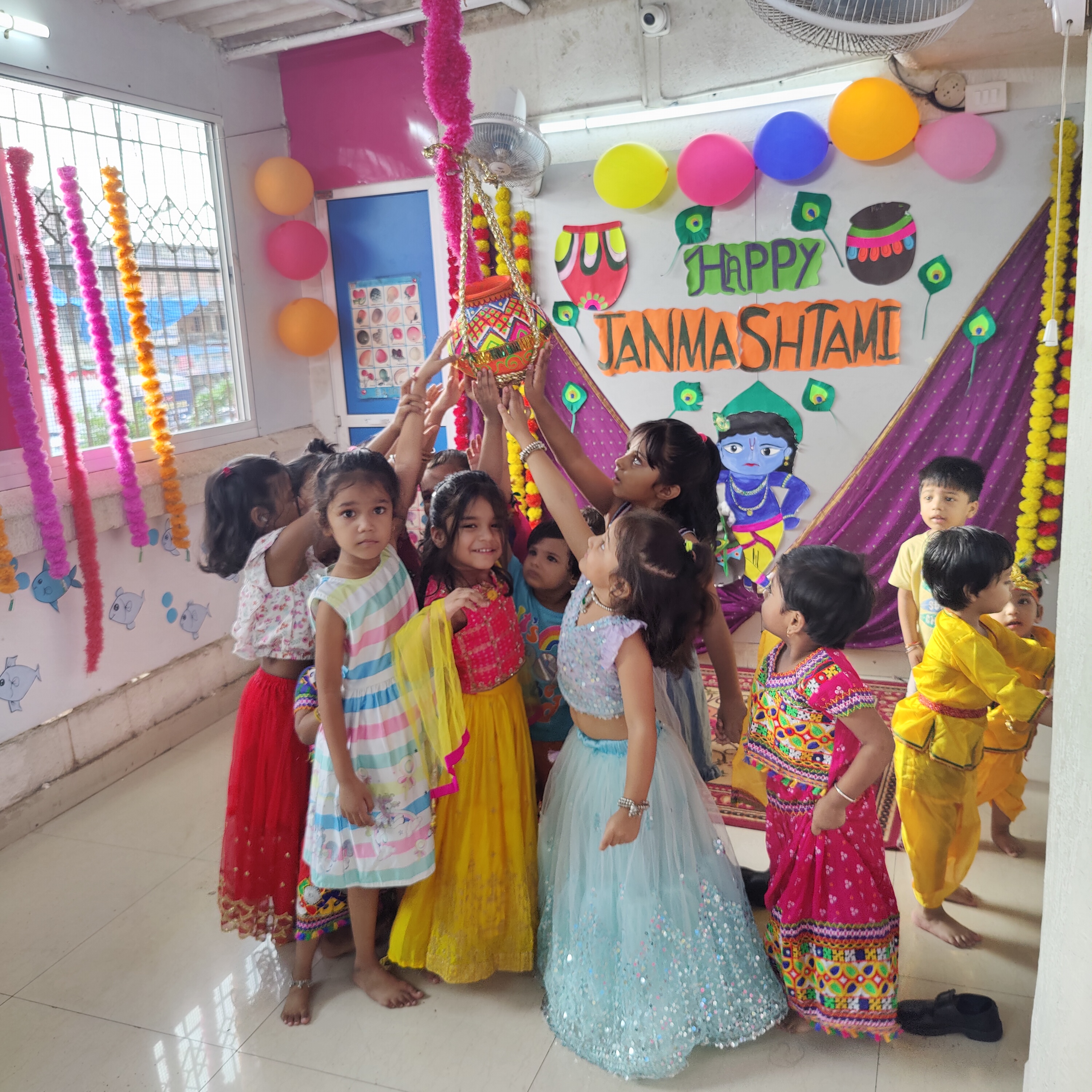 Students enjoying Janmashtami festivities in traditional attire